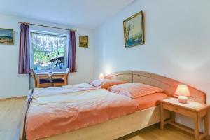 a bedroom with a bed and a table and a window at Katharinenhof Wohnung Kramer (2) in Garmisch-Partenkirchen