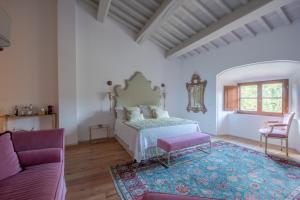 a living room filled with furniture and a window at Castello Di Meleto Wine Destination - Camere in Castello e Appartamenti in Gaiole in Chianti