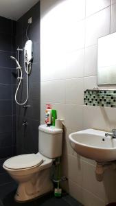 a bathroom with a toilet and a sink at Sweet Sweet Zenith Johor Bahru in Johor Bahru