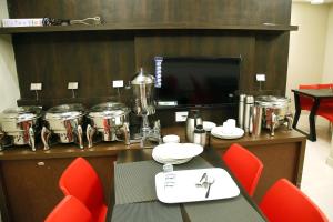 a room with a table with drums on a wall at Grand Oliver in Chennai