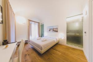 Posteľ alebo postele v izbe v ubytovaní Cefalù Design Suites