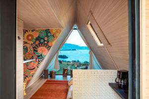 a room with a large window in a house at La Quinta Glamping - Lago de Tota in Cuítiva