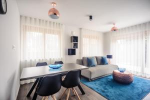 a living room with a table and chairs and a couch at Apartments Villa Tatiana in Bled
