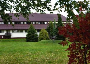 a house with a yard in front of a building at Zajazd Boryna in Wieluń