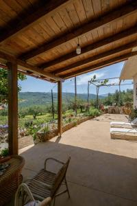 a patio with a table and chairs and a view at Traditional Family Cretan Home! in Yerakianá