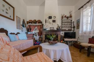 a living room with a couch and a table at Traditional Family Cretan Home! in Yerakianá