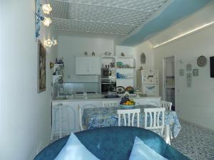 een keuken en eetkamer met een tafel en stoelen bij Maison de charme Villa Mavi in Praiano