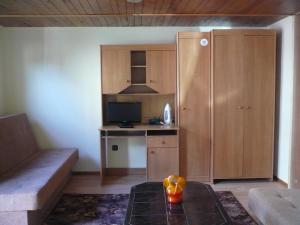 a small kitchen with a desk with a computer at Pokoje gościnne u Andrzeja in Radków