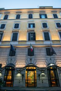 a building with flags on the front of it at Hotel Windrose in Rome