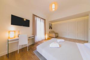 Posteľ alebo postele v izbe v ubytovaní Cefalù Design Suites