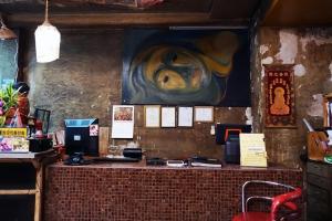 a counter with a painting on the wall at DDM House in Bangkok