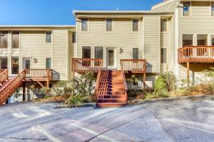 a apartment building with a staircase in a parking lot at Crest 200F in Sugar Mountain