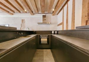 an empty kitchen with a sink and a counter at Outstanding Luxury Flat 4P-Boulevard Saint Germain in Paris