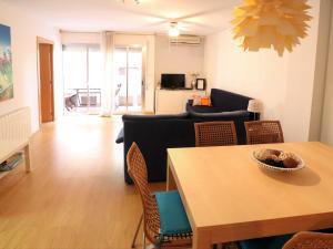 sala de estar con mesa y sofá en Metropol apto per 5 pax primera linea mar d22223, en Sant Feliu de Guíxols
