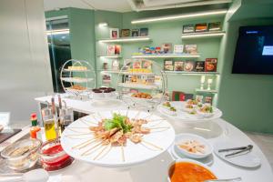 a buffet with plates of food on a table at Hotel Vista in Pattaya Central