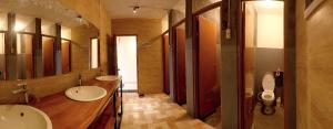 a bathroom with two sinks and a toilet at Tani Jiwo Hostel in Dieng