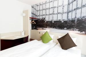 Postel nebo postele na pokoji v ubytování B&B HOTEL Zürich Wallisellen