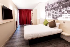 Postel nebo postele na pokoji v ubytování B&B HOTEL Zürich Wallisellen