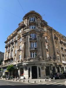 a large building on the corner of a street at Victoria Luxury Apartment 11 in Bucharest