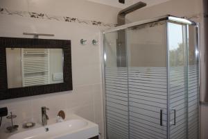 W łazience znajduje się szklana kabina prysznicowa i umywalka. w obiekcie Res. Chalet a 10 min. da Rho Fiera e Stadio Meazza w Mediolanie