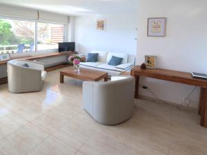 a living room with a couch and a table at Urcatusa Llevant - Apartamento 6 pax con piscina g27034 in Sant Feliu de Guíxols