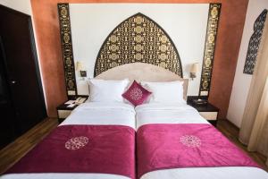 A bed or beds in a room at El Minzah Hotel