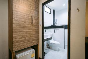 a bathroom with a toilet and a sink at Jintana Resort in Buriram