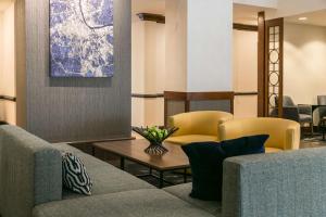 a lobby with a couch and chairs and a table at Hyatt Place Nashville Franklin Cool Springs in Franklin