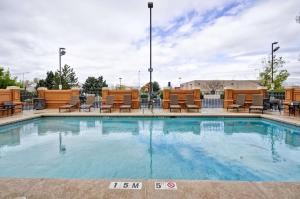 a large swimming pool with chairs at Hyatt Place Albuquerque Uptown in Albuquerque