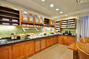 a large kitchen with wooden cabinets and a table at Hyatt Place Tampa Airport/Westshore in Tampa