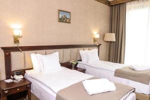 Voodi või voodid majutusasutuse Konyak Hotel toas