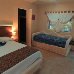 Ένα ή περισσότερα κρεβάτια σε δωμάτιο στο Casa Tzalam Tulum selva