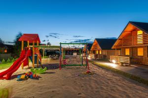 a playground in the sand near a house at TRZĘSAWISKO in Trzęsacz