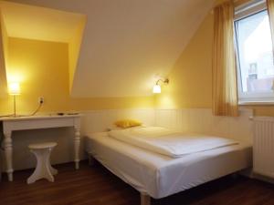 a small bedroom with a bed and a window at Villa Sipeky in Senec