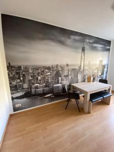 a dining room with a wall mural of a city at Cottbuser City Ferienwohnung in Cottbus