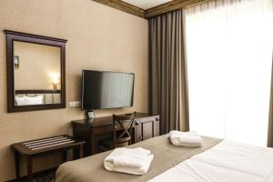 Voodi või voodid majutusasutuse Konyak Hotel toas