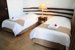 Säng eller sängar i ett rum på Hotel Sol de Ica