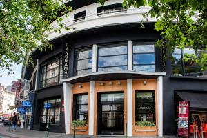 a black and white building with large windows at Hôtel Panorama in Lourdes