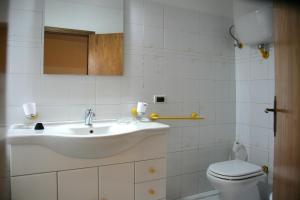 a bathroom with a sink and a toilet at Maison Vannina in Marsciano +12 photos