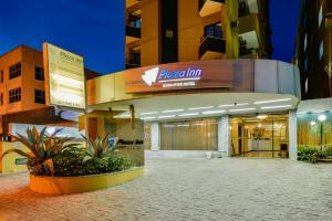 a building with a sign on the front of it at Plaza Inn Executive in Goiânia