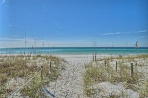 a sandy beach with the ocean in the background at Dunes of Panama in Panama City Beach