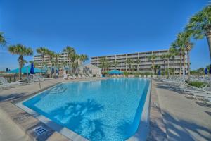 a swimming pool at a resort with palm trees at Dunes of Panama in Panama City Beach
