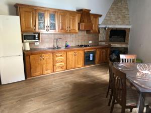 a kitchen with wooden cabinets and a table with chairs at Teide in Icod de los Vinos