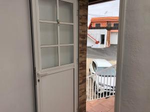 a door to a balcony with a view of a house at Teide in Icod de los Vinos