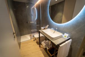 a bathroom with a sink and a mirror at Hotel Taburiente S.C.Tenerife in Santa Cruz de Tenerife