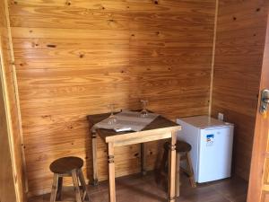 a small room with a table and two stools at Pousada Santa Terezinha in Urubici