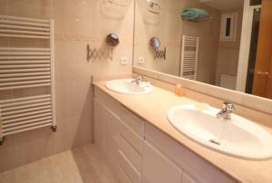 a bathroom with two sinks and a mirror at Urcatusa Llevant - Apartamento 6 pax con piscina g27034 in Sant Feliu de Guíxols