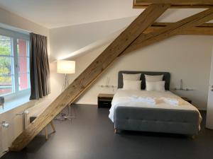 a bedroom with a large bed and a loft at Relais du Simplon in Conthey