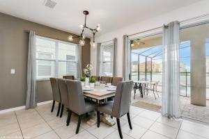 a dining room with a table and chairs at Veranda Palms 8 Bedroom Home with Pool - 1722 in Kissimmee