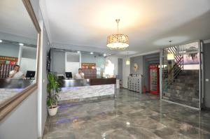 a lobby of a restaurant with a counter and stairs at Reis Maris Hotel in Marmaris